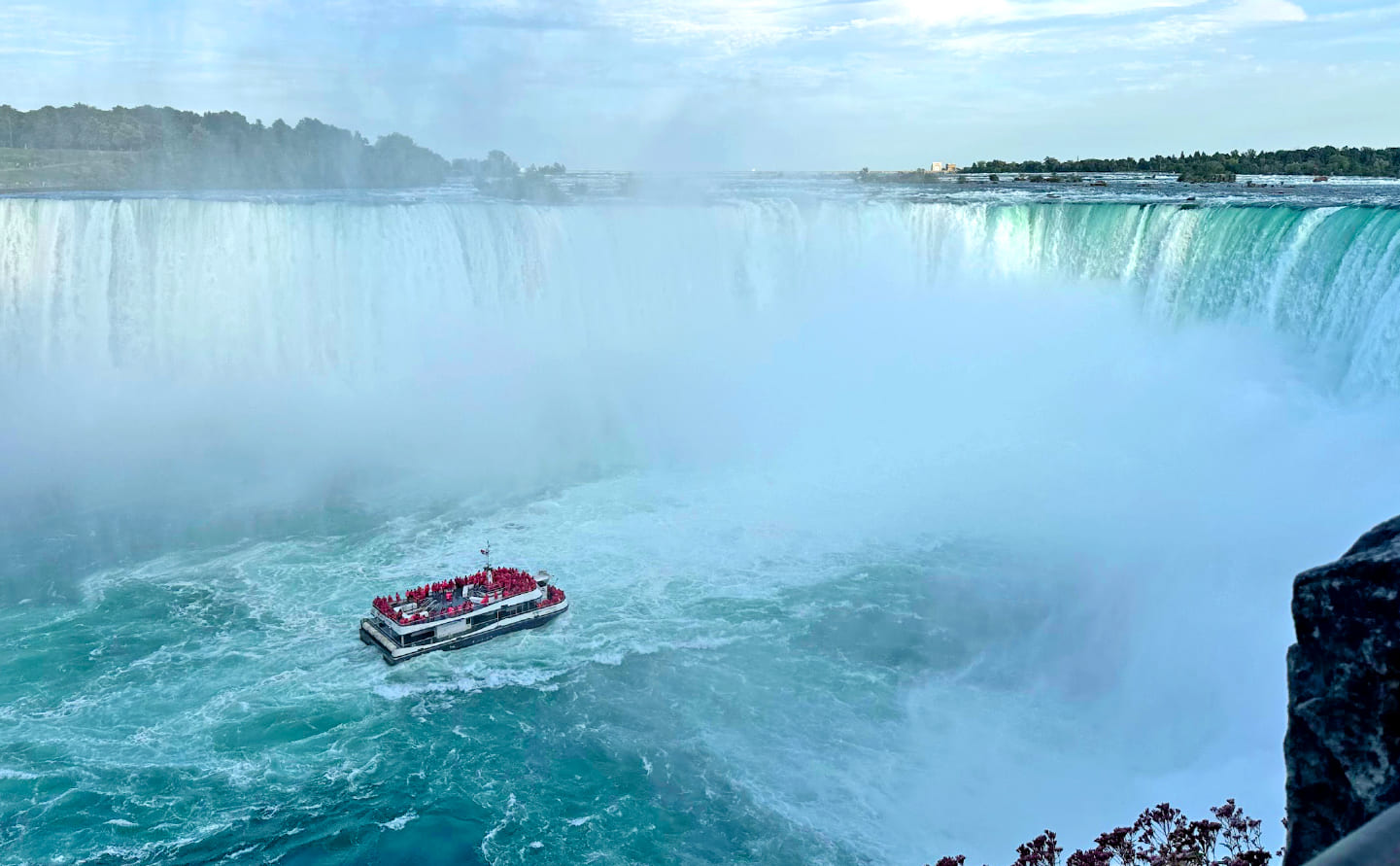 A sightseeing boat approaches the base of Niagara Falls