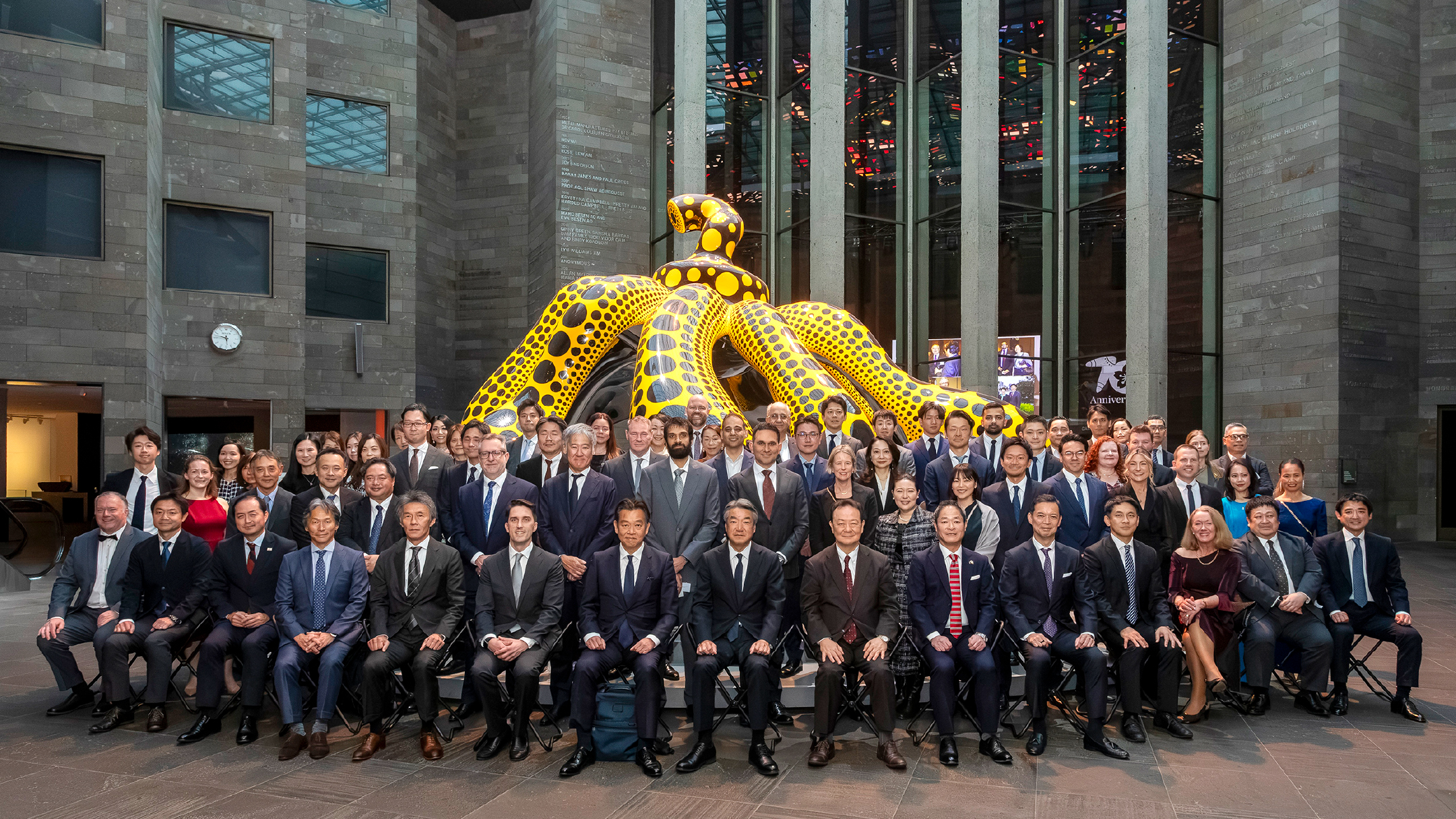 Participants from the Mitsubishi Corporation Group in front of “Dancing Pumpkin,” a work by Yayoi Kusama on display at NGV